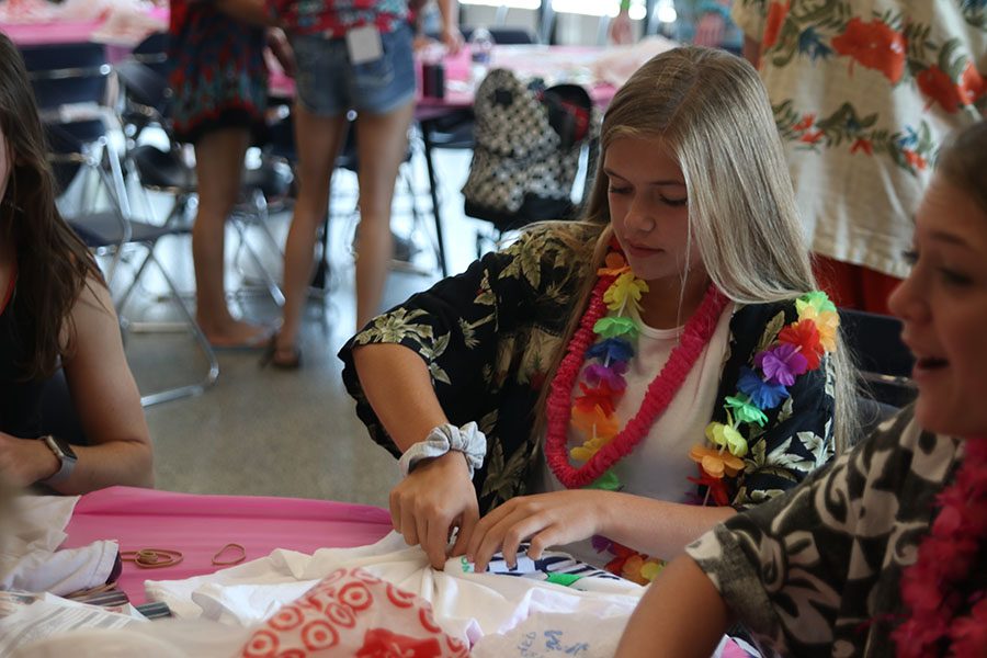 Freshman Brianna Coup twists her T-shirt in order to tie-dye it.