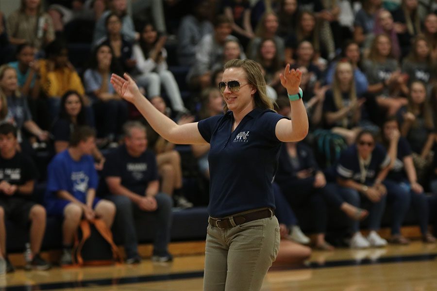 Walking out to the center of the gym, English teacher Page Anderson prepares to help with the homecoming candidate game.