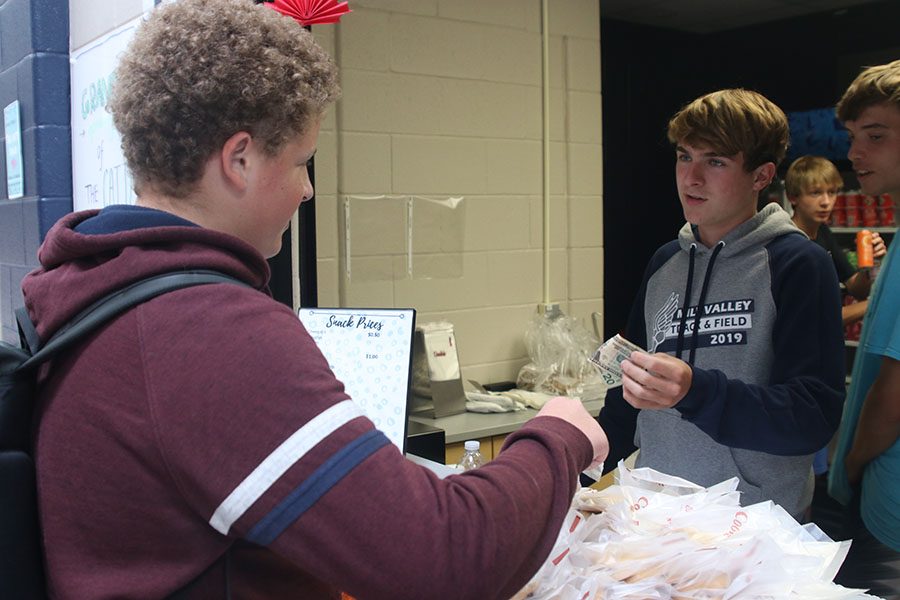 On the opening day of the Catty Shack, sophomore Declan Taylor buys his hot cookie.