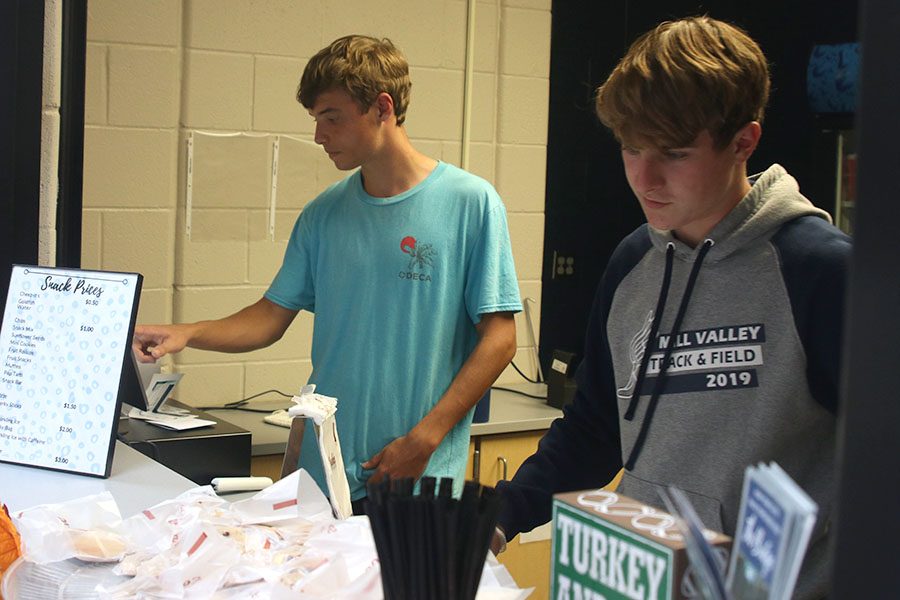 In the midst of a big rush, seniors Nick Schmidt and Josh Glunt man the Catty Shack on Tuesday, Sept. 24.
