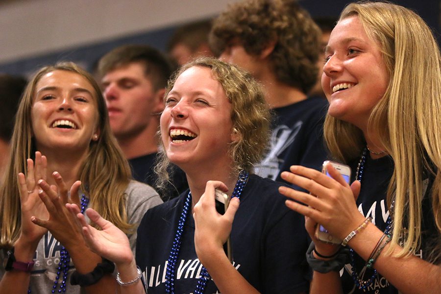 Laughing, seniors Molly Haymaker, Allison Godfrey, and Jenna Walker sing along to the school fight song.