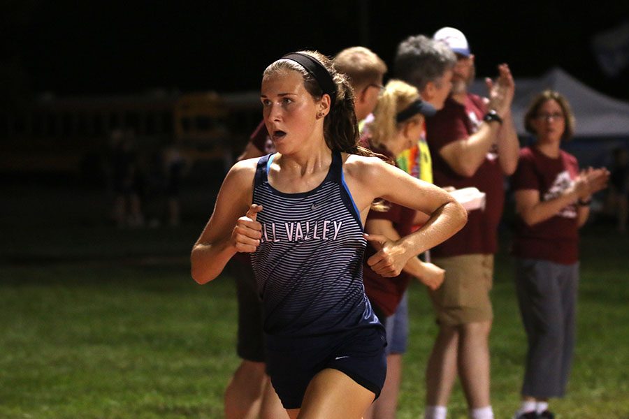 Leading the race, senior Morgan Koca secures her first place finish in the girls varsity race.