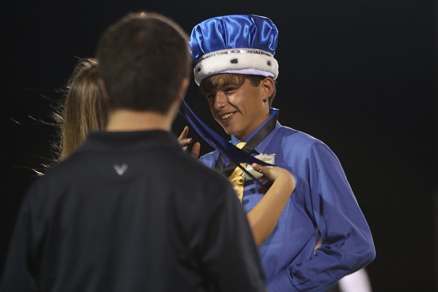 Being crowned, homecoming king winner Ben Stove smiles. 