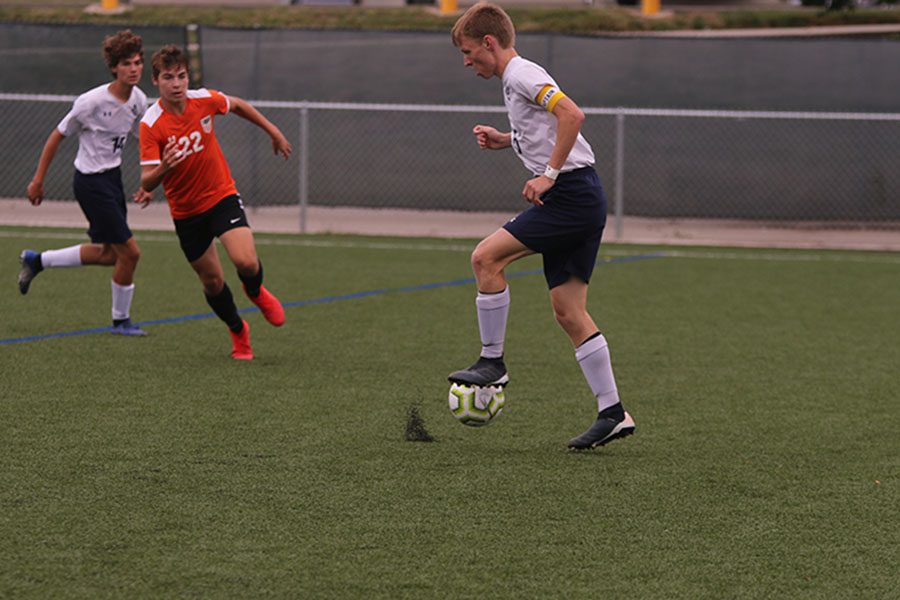 After the ball is passed from his teammate, senior Ian Carroll opens his foot to receive the ball. 