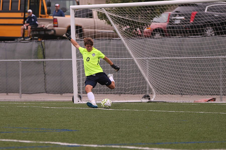 After the ball is kicked out near goal, freshman Colin Riley winds his leg back and kicks a goal kick. 