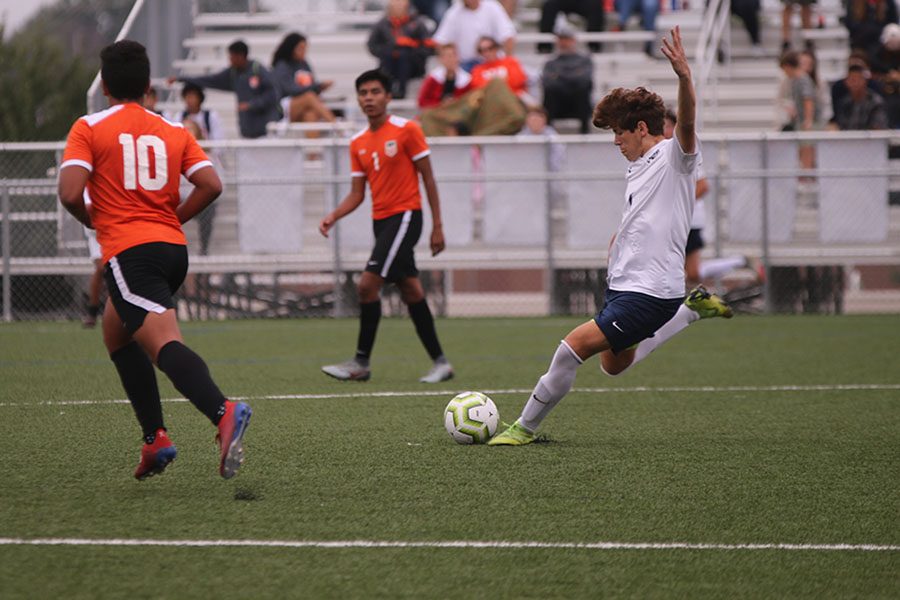 Preparing to boot the ball up the field, sophomore Yahel Anderson winds his leg back. 