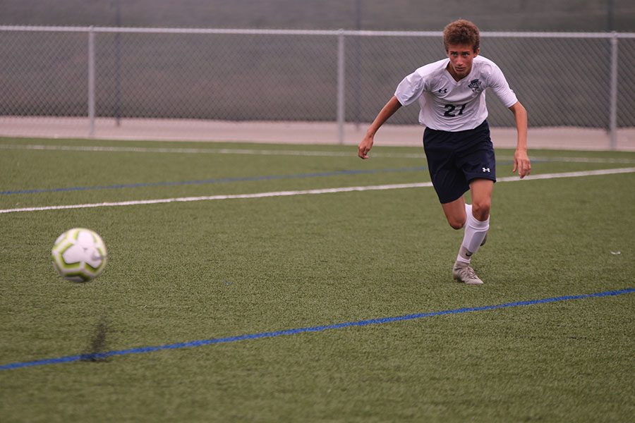 After the ball is passed into open space, freshman Dylan Ashford sprints after the ball. 