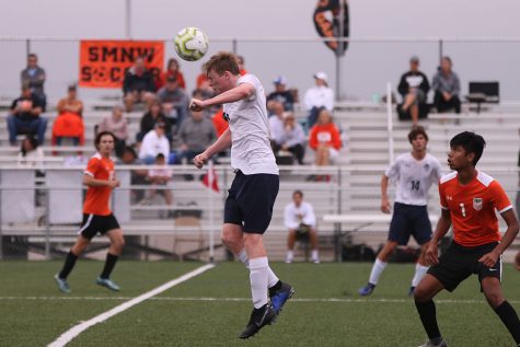 After the ball is punted down the field by the opposing keeper, senior Will Coacher jumps up to the receive the ball with his head. The game ended in a 2-2 tie Saturday, Sept. 28.