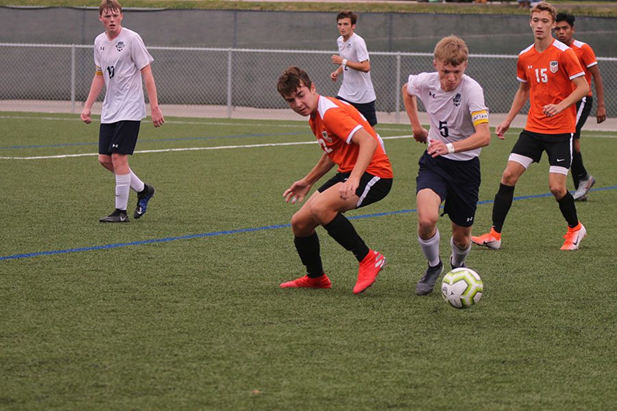 After stealing the ball from his opponent, senior Ian Carroll breaks away and pushes up the field.