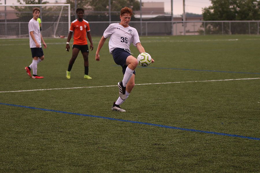 Trying to control the ball in the air, freshman Owen Peachee bounces the ball on the top of his foot. 