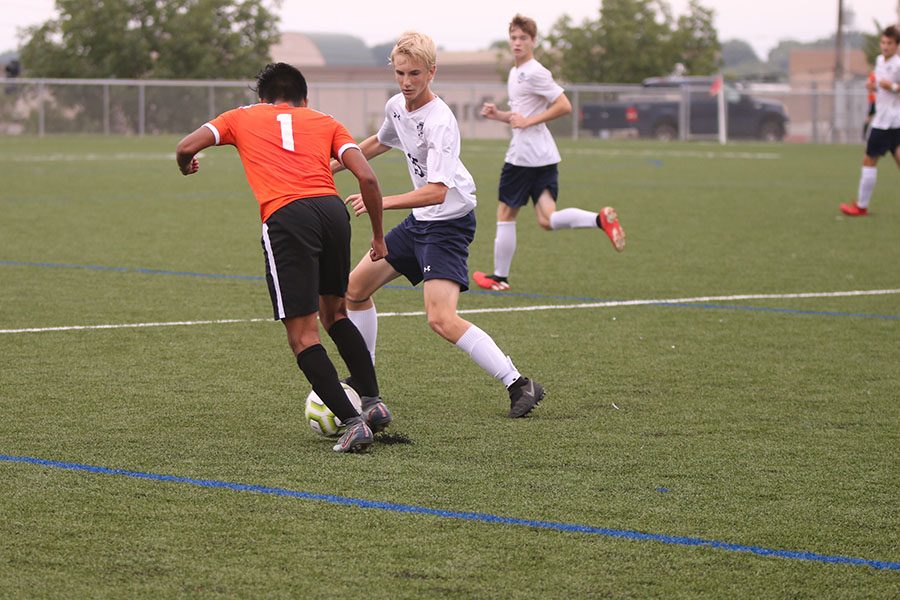 Studying his opponents footwork, sophomore Sutton Sick shuffles his feet as he moves up the field. 