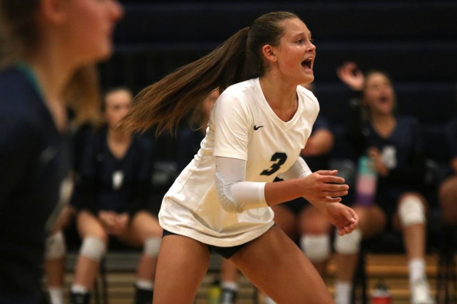 Calling out encouragement to her teammates, junior Jaden Ravnsborg maintains focus during the first volleyball match of the season against Spring Hill on Friday, August 30. Ravsborg has verbally committed to playing for Kansas State University’s volleyball team.
