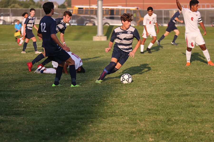 After receiving the ball, sophomore Yahel Anderson pushes the ball up the field towards the goal. 