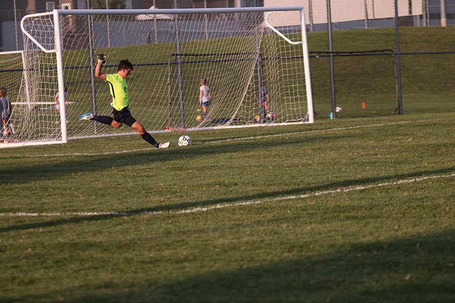 In goal kick motion, freshman Colin Riley winds his leg back and kicks the ball down the field. 
