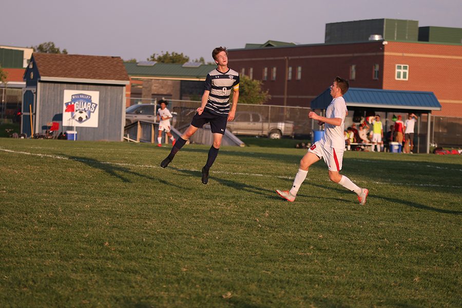 After the ball is volleyed into the air by a teammate, junior Greyden Gustafson jumps in the air to head the ball. 