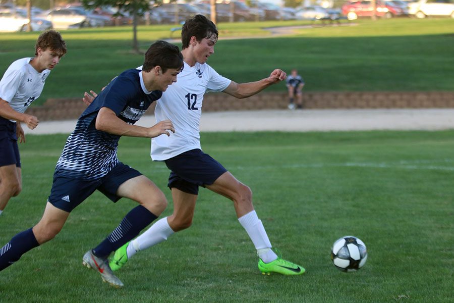 Retrieving the ball, senior Anthony Pentola gets ahead of his opponent.