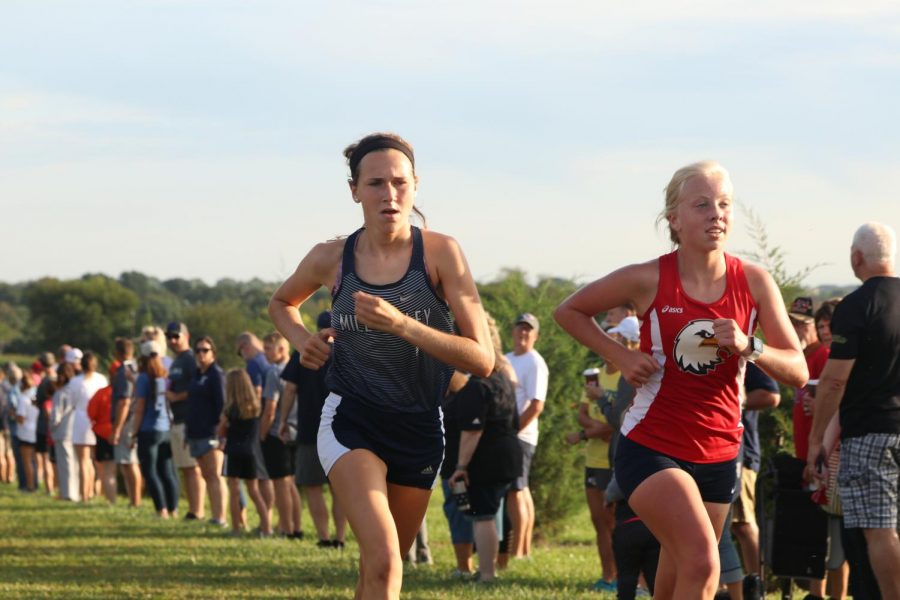 Close behind her opponent, senior Morgan Koca gets ready to run past her.