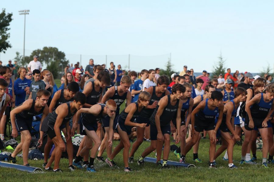 Lining up to start the race the varsity boys listen for the start signal and stand in their positions.

