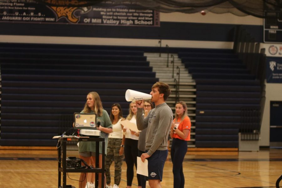 Saying a chant into the crowd, senior Cline Boone demonstrates how to cheer at football games