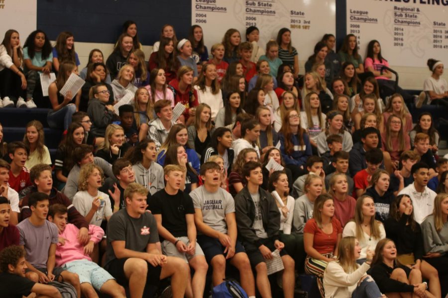 Watching to see which chant is next, students sit in the stands at the pep rally held during seminar Tuesday, Sept. 24