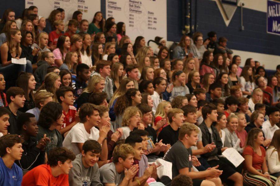 Watching to see which chant is next, students sit in the stands at the pep rally held in seminar Tuesday, Sept. 24