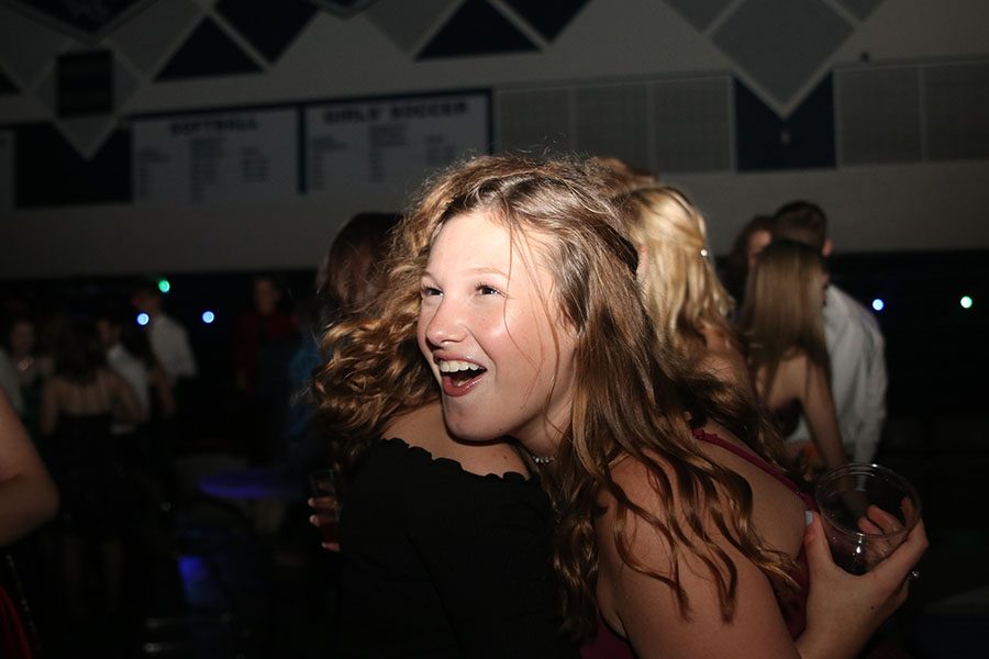 Smiling, sophomore Carlee Liby hugs her friend from Desoto.