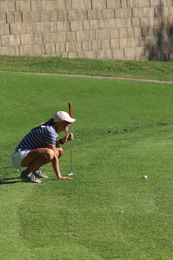 Looking to the hole, junior Megan Haymaker lines up her shot.
