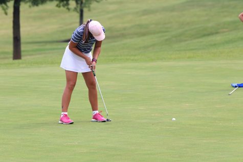 With a putter in hand, sophomore Libby Green follows through finishing her hole. Green won third place overall at the Shawnee Golf and Country Club on Tuesday, Sept. 10.
