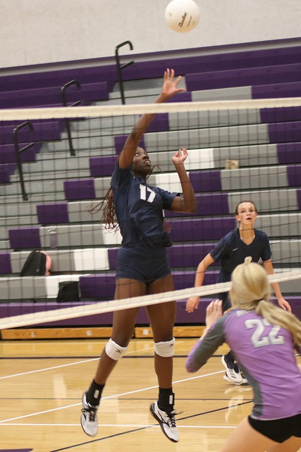 Senior faith Archibong jumps to tip the ball over the net.