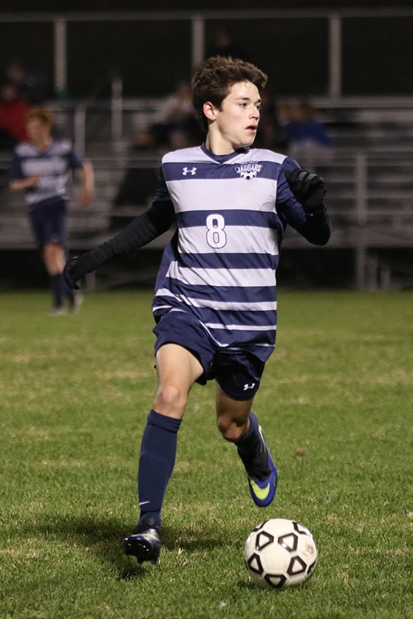 Junior Cael Denney looks to connect the ball with one of his teammates.
