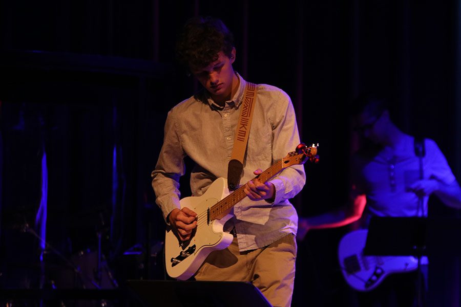 In front of the congregation at Grace United Methodist Church, junior John Fraka plays his guitar in worship on Sunday, Sept. 29.