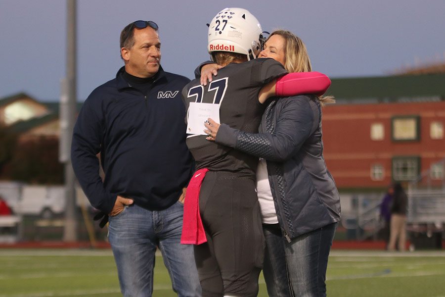 After walking on field, senior Grant Frost hugs his mom. 