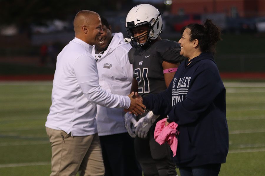 Walking down the line of seniors on the field, coach Applebee shakes each players and parents hand. 