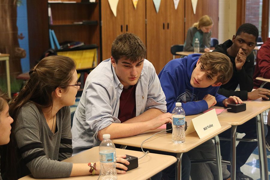 During round two against Eudora, the team discusses possible answers to a question Thursday, Oct. 24. The team ended the tournament at Tonganoxie with a 5-1 record.