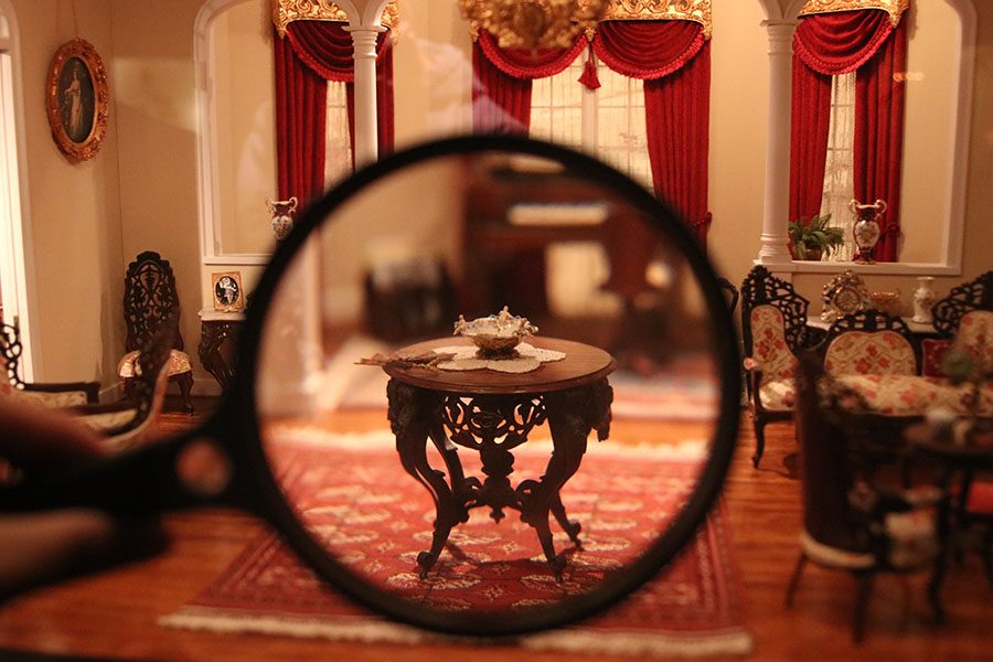 In the miniatures section in The National Museum of Toys and miniatures, a historic room features intricate pieces of furniture.