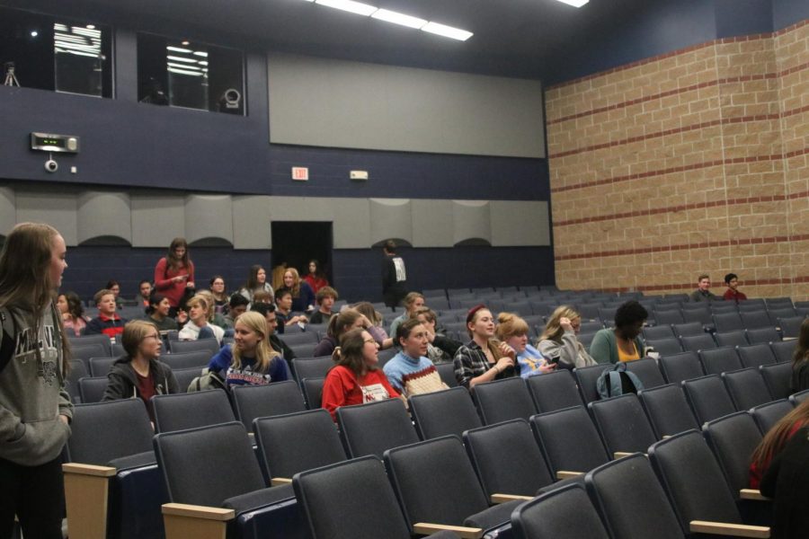 Sitting in the little theater, students get ready to watch movies shown at the film fest during seminar.