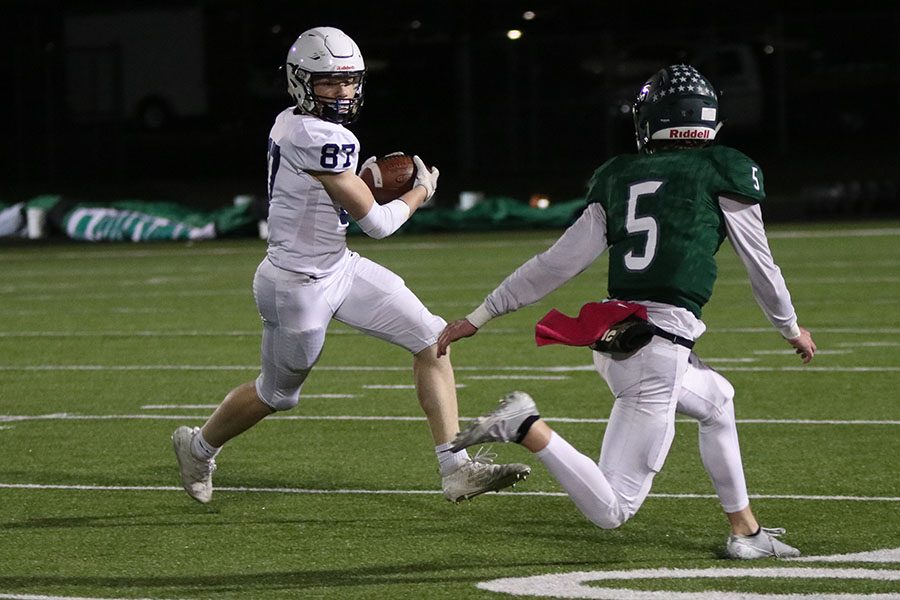 Carrying the ball, sophomore Jared Napoli doges a BVSW defender.