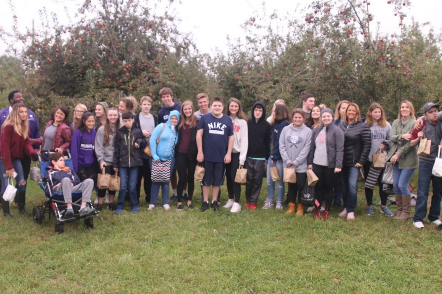 The class of Peers in Learning students enjoy their time at the apple orchard.
