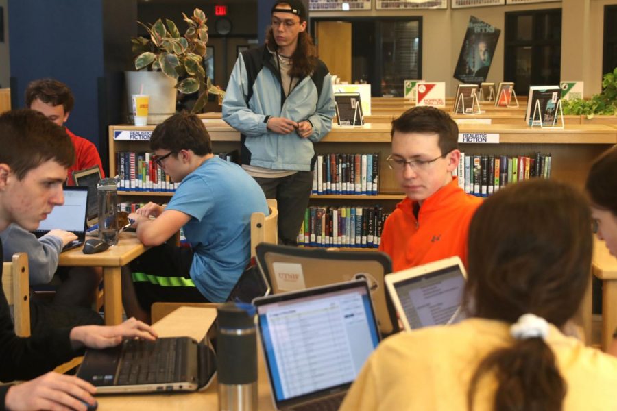 Debate gets ready for their trip to Oklahoma City, Oklahoma by gathering in the library to share information and strategies. 