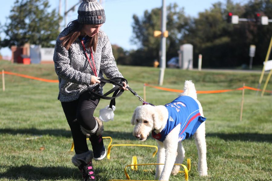 Running with her dog, senior Rylee McElroy participates in the obstacle course.