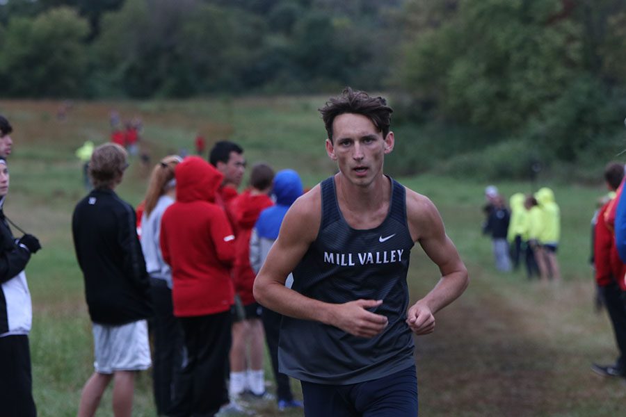 Running ahead of everyone, senior Darius Hightower leads the way in the Mill Valley Cat Classic Thursday, Oct. 10.  Hightower went on to break the school record and win the EKL championship on Thursday, Oct. 17 at JCCC.