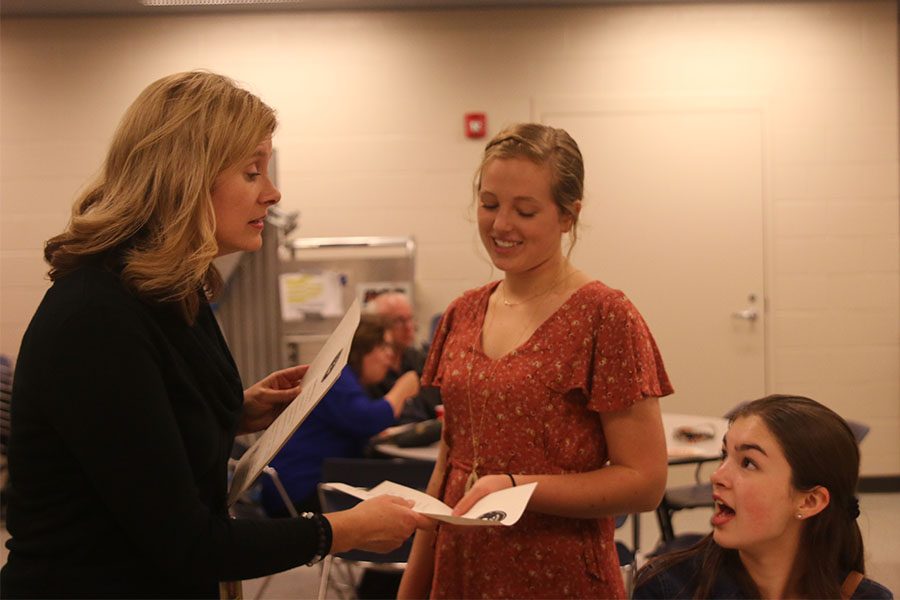 Spanish teacher Jan Good-Bollinger hands sophomore Damara Stevens her certificate. 