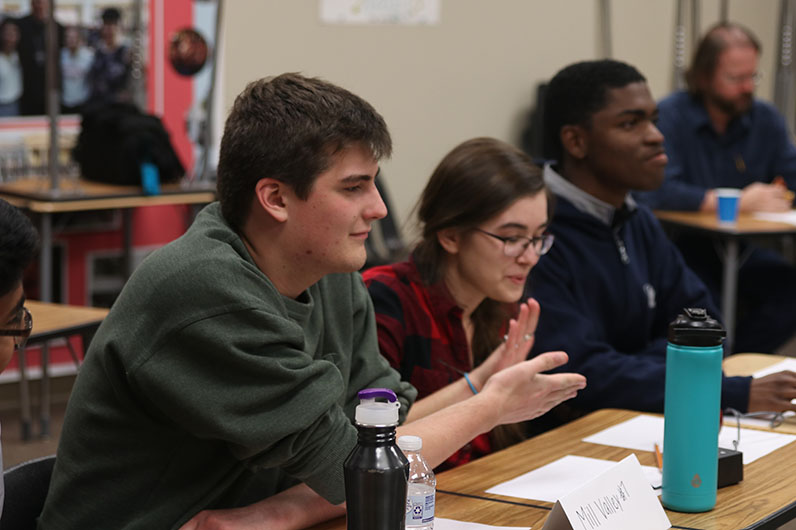 After correctly answering a language arts question, seniors Joan Downey and Noah Hookstra high five each other. The team placed second at Saint James Tuesday, Oct. 29.