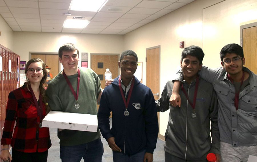 The five members of the Quiz Bowl team that competed at Saint James stand together after receiving medals for placing second.