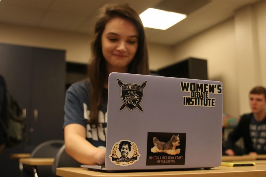 Using software designated for debate, sophomore Taylor Doyle types on her personal laptop that she customized with a #FreeBrutus sticker. 
