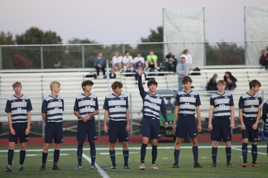 Before the game has started, senior Anthony Pentola waves after getting introduced.
