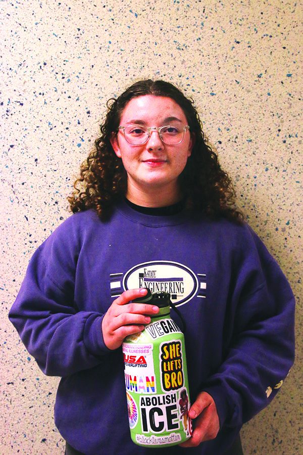 While holding her sticker-covered water bottle, junior Gabriella Hantla smiles. Featured on her water bottle are many unique stickers from a political  “Immigrants Make America Great” sticker to a fun “She Lifts Bro” sticker. 

