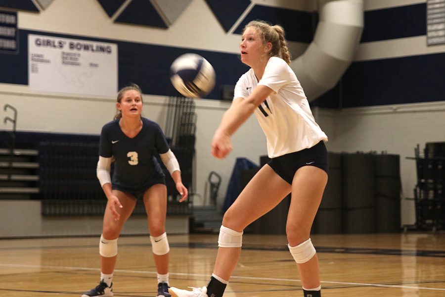 Hitting the volleyball, sophomore Kate Roth uses force to ensure that the ball makes it over the net.