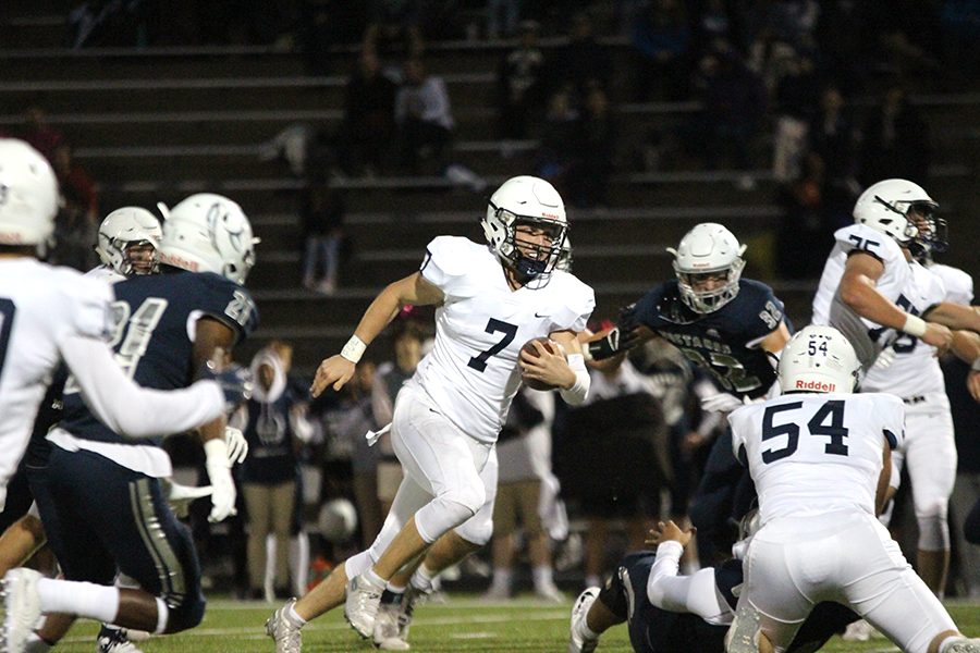 Running the ball through the center of the field, junior Cooper Marsh spots an opening in the field and attempts to score a touchdown on Friday, Oct. 4.
