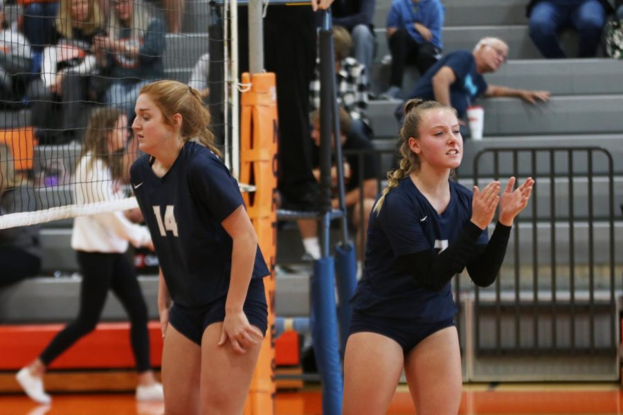 After scoring a point, sophomore Sydney Fiatte rallies the team before the next serve. 